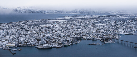 A panorama wide shot of the harbour city of Tromsø, Norway, in winter.
