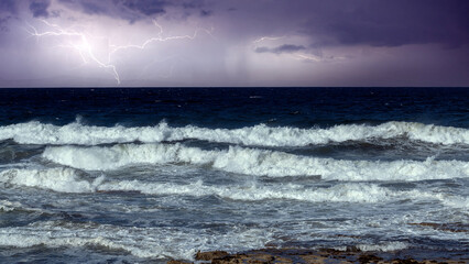 A turbulent sea churns under a stormy sky, illuminated by jagged lightning bolts.