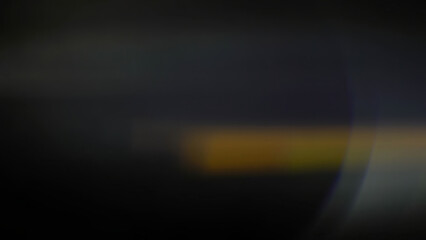 Cinematic anamorphic lens flares with vivid light streaks and reflections against a black...