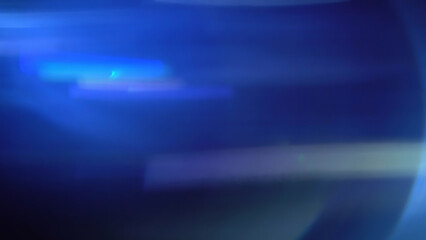 Cinematic anamorphic lens flares with vivid light streaks and reflections against a black background, creating a dynamic and glowing optical effect.