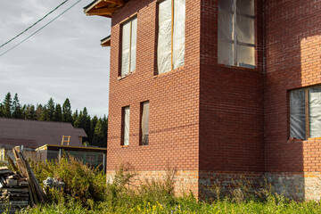 Unfinished two-storey brick house. High foundation. An abandoned house