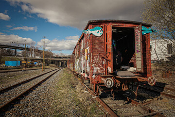 And old railway car sits abandoned in a railyard.