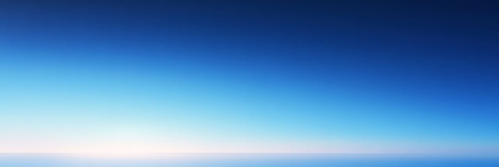 Obraz premium A stunning image of a blue sky gradient, transitioning from a deep blue at the top to a soft, pale blue at the horizon. The gradient creates a sense of depth and peace, symbolizing calmness, freedom, 
