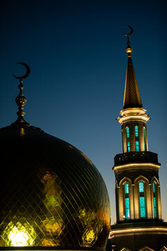 A beautiful mosque that features a crescent moon on its rooftop