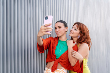 Lesbian couple taking a selfie with affectionate expressions