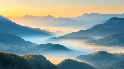 Obraz premium Misty mountain landscape at sunrise with layered