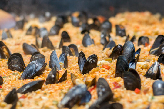 Close up of traditional Spanish paella cooking in a big pan