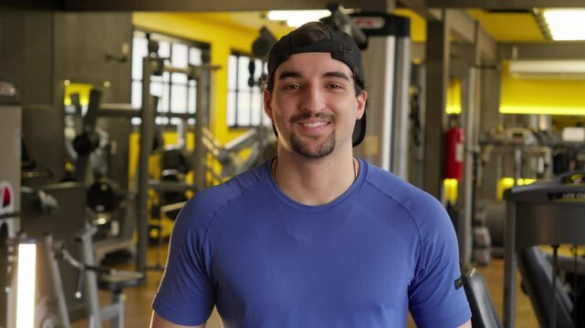 Smiling Fitness man in a Friendly Gym Environment. Portrait of a Man Smiling after a Workout in a Modern Gym Setting, Showing Positivity and Motivation