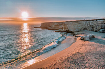 Beautiful sunset landscape along Highway 1 in California. Pacific Ocean coastline along the bay, aerial view. Travel and vacation concept.