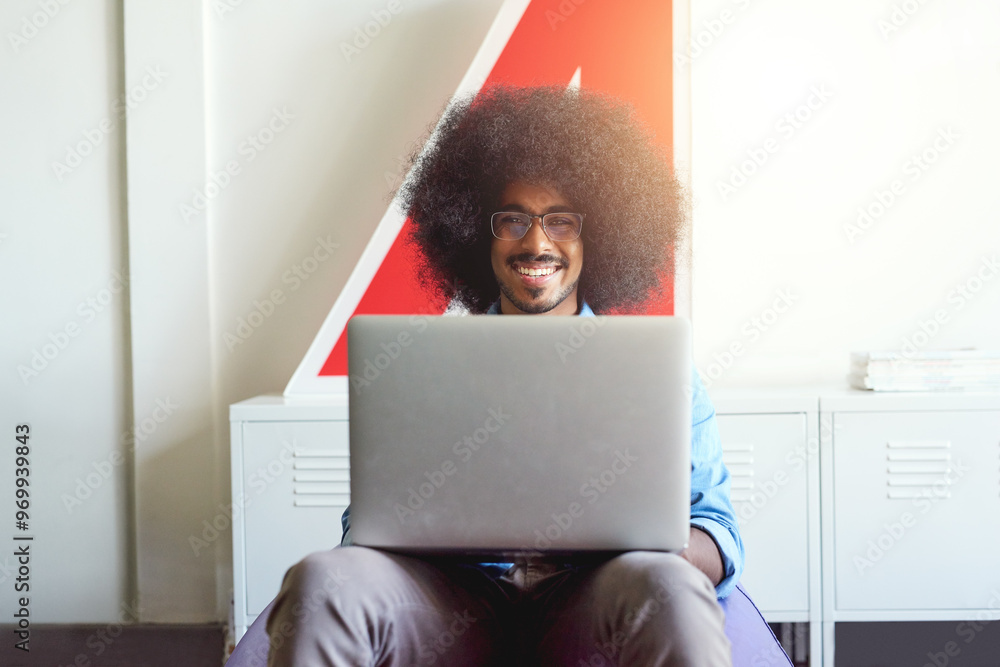Poster Laptop, portrait and smile with designer man in creative workplace for administration or web development. Afro, business and computer with happy developer in office for information or research