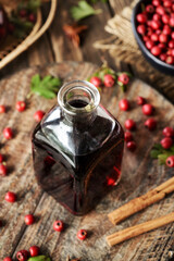 A bottle of medicinal wine prepared from wild hawthorn berries in autumn
