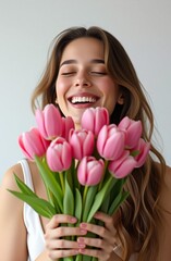 Fototapeta premium beautiful woman, girl smiling and holding a big bouquet of pink tulips, holiday, gifts, flower delivery, love, dating, spring, romance
