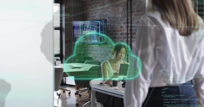 Animation of cloud icon and data processing over diverse businesswomen in office - Powered by Adobe