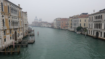 Venice in December, shrouded in mist and without sunlight, captures a serene and atmospheric winter beauty. Historic canals, iconic landmarks, and a tranquil ambiance define this unique, foggy scene.
