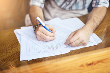 Hands, man and writing with documents at cafe for finance planning, vendor contract and inventory...