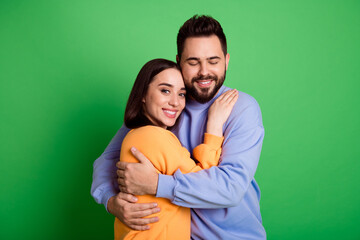 Photo of pretty cute tender charming couple wear stylish clothes isolated on green color background