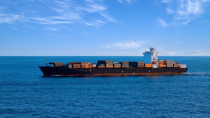 International commerce container cargo ship delivering freight shipment across the ocean.