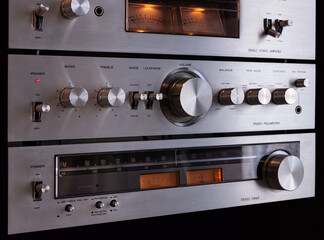 Fototapeta premium Vintage Audio Stereo Gear Separate Components System Setup, Tuner, pre-Amplifier, Power Amplifier. Metal Front Panel, Angled View Closeup