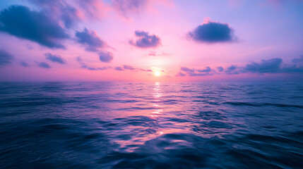 A mesmerizing ocean view at dusk with the sky painted in deep purples and pinks reflecting on the water.