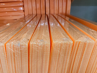 This closeup shows a neatly stacked set of plasticwrapped books, preserving their condition and keeping them organized for easy access and display for readers or admirers