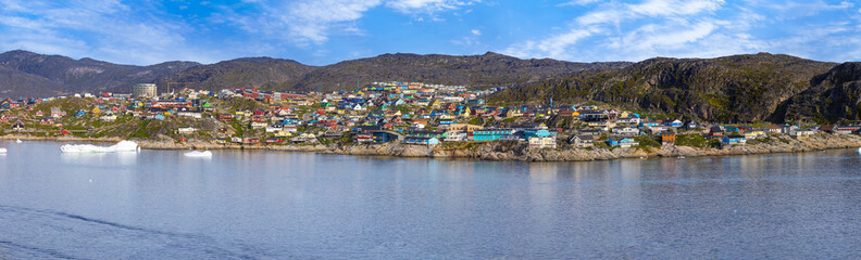 Typical architecture of Greenland Ilulissat with colored houses located near fjords and icebergs.
