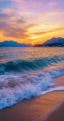 Golden sunset over calm waves at a beach with distant hills in the background