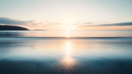 Obraz premium A serene ocean view from a secluded beach with the sun rising over the calm water and creating a soft golden reflection.