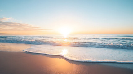 Fototapeta premium A serene ocean view from a secluded beach with the sun rising over the calm water and creating a soft golden reflection.
