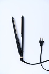 Hair straightening iron with cord on white background
