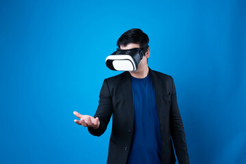 Profile of businessman wearing VR device connecting metaverse, holding stuff in the air isolated blue background futuristic analytics communication technology virtual reality copyspace. Contrivance.