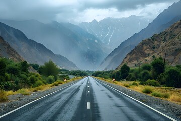 Fototapeta premium Serene Mountain Road Under Cloudy Skies