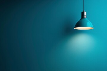 A Single Blue Pendant Light Against a Textured Teal Wall