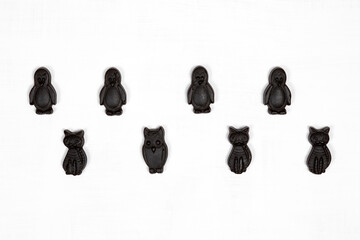 Black licorice candies in the shape of penguins, cats and owls