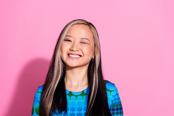 Photo of adorable lovely girl wear print top winking eye empty space isolated pink color background