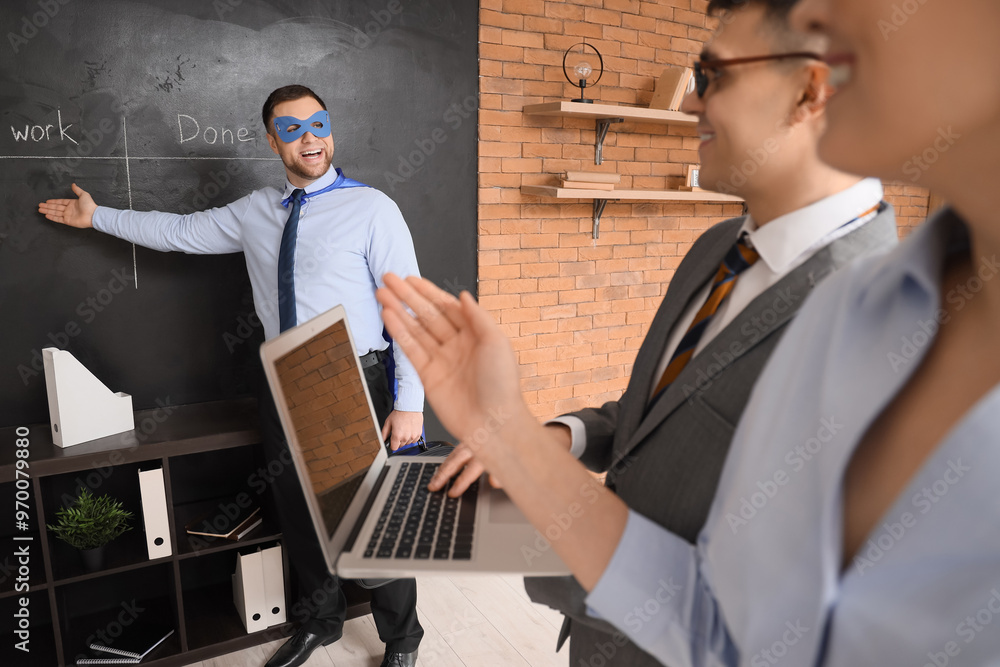 Canvas Prints Business man dressed as superhero giving presentation to his colleagues in office