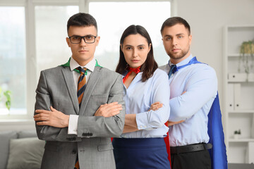 Business people dressed as superheroes in office