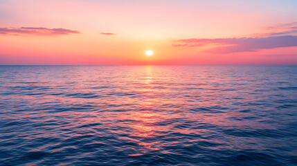 Obraz premium A serene sunset over a calm ocean with the sun dipping below the horizon and the sky painted in shades of orange pink and purple.