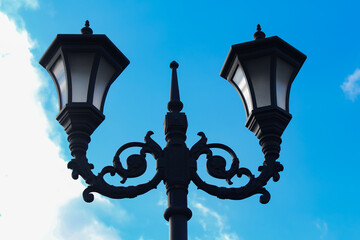 Isolated lamppost against blue sky