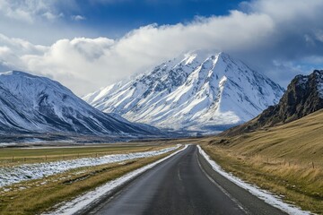 Fototapeta premium Side view of a snowcapped mountain and road panoramic view