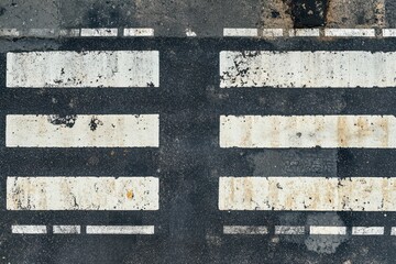 Fototapeta premium Smooth asphalt road with stripes and crosswalk tarmac texture from above