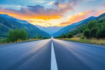 Naklejka premium Sunset over mountain with asphalt road and sky clouds