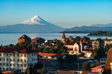 Skyline of the city of Puerto Varas on a clear and sunny winter day, with the Osorno volcano by...