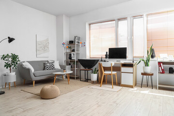 Beautiful office with desk, modern computer and sofa. Photographer workplace concept