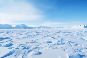 Snow covered landscape with mountains in the background.