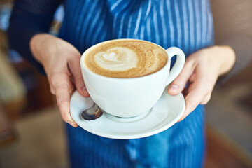 Hands, coffee and waitress in restaurant or bistro for customer service, order or serving as worker. Person, hot beverage and small business with latte in cafe, hospitality and industry as barista
