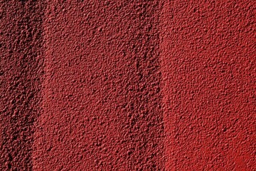 Red textured background with rubber coating for sports surfaces close up from above