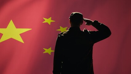 Member of chinese army doing saluting hand gesture towards China flag in command center, showing...