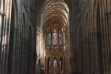 Naklejka premium Sunlight streaming through stained glass windows in gothic St. Vitus Cathedral. Prague, Czech Republic