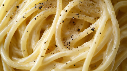 a close-up, top-down view of cacio e pepe, filling the entire frame with the focus on the pasta's intricate details