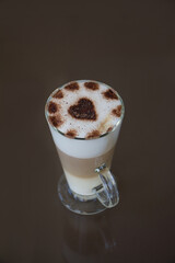 Tall glass cup with latte coffee, closeup